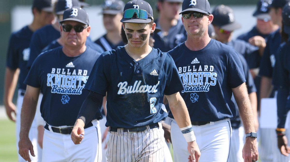 Bullard’s Beckett Zavorek, center, walks off the field with the team after the Knights defeated the Edison Tigers 2-0 in a County/Metro Athletic Conference baseball game Saturday, March 26, 2022 in Fresno.
