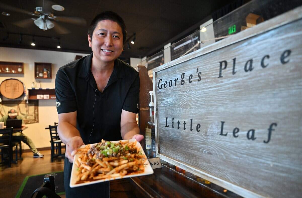 George Widjaja, owner of Little Leaf Bar & Restaurant, holds a plate of his Kimchi Fries Wednesday, July 15, 2026 in Fresno.