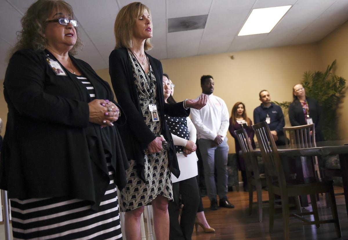 Catholic Charities staff gather in a private prayer circle led by Catholic Bishop Armando Xavier Ochoa Wednesday, April 18, 2018 in Fresno. The prayer circle was held to support staff on the one-year anniversary of Kori Ali Muhammad killing one man outside Catholic Charities and two others nearby.