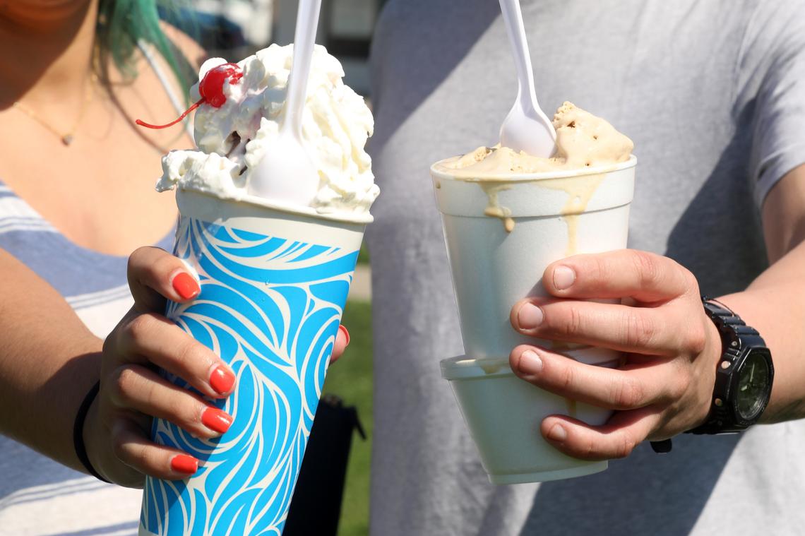 Eva Gonzalez, of Fresno with a banana split and Julio Torres with a scoop of coffee ice cream outside of Superior Dairy in Hanford, California on Wednesday, March 26, 2025. The beloved ice cream spot, a&nbsp;landmark in the Central Valley since 1929, has new owners - the Zonneveld family, a local dairy family with deep roots in Kings County.&nbsp;