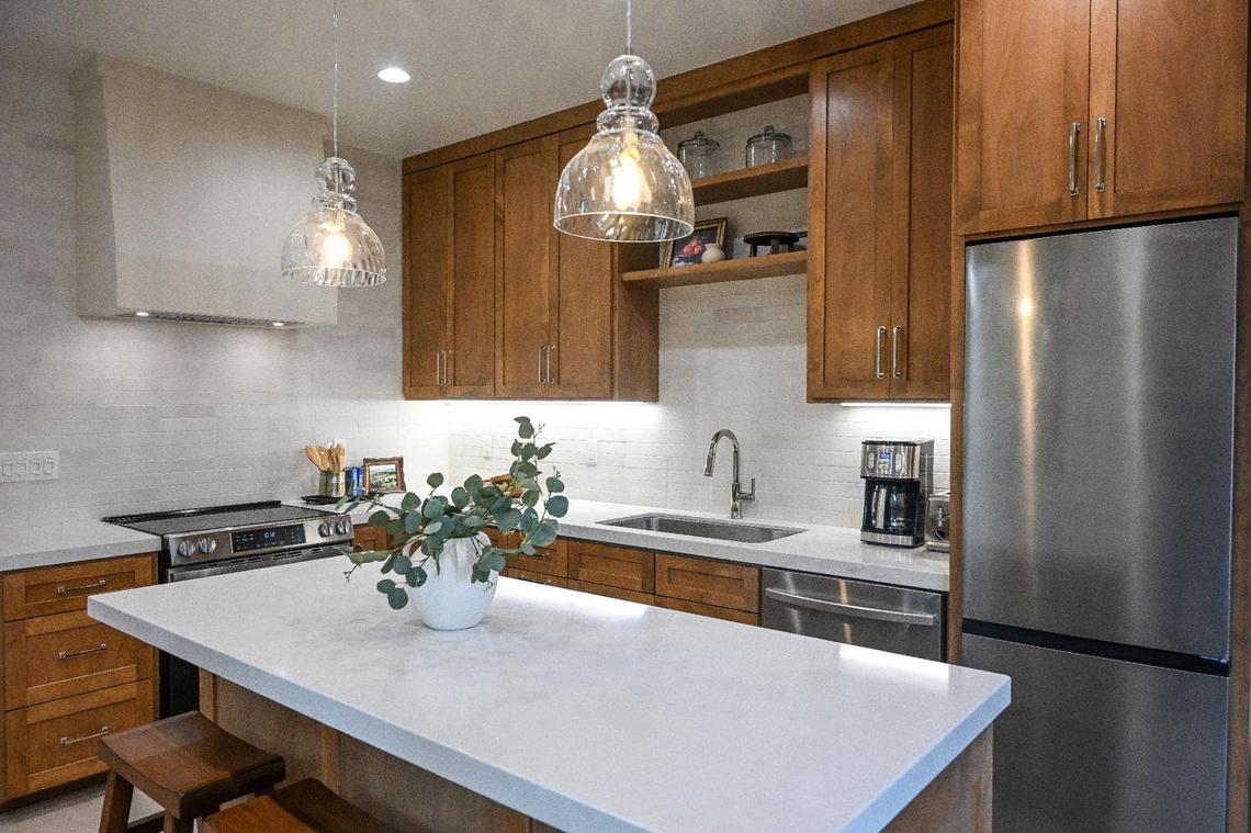 A kitchen with full amenities is shown at a recently completed accessory dwelling unit or ADU sitting adjacent to a house on a lot in Fresno neighborhood. Property owner Brandon Telesmanic had the home built as a rental property which is a growing trend in Fresno.