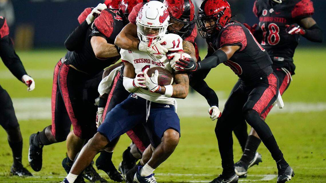 Fresno State wide receiver Josh Kelly is defended by San Diego State players during the first half of an NCAA college football game Saturday, Oct. 30, 2021, in Carson, Calif. (AP Photo/Jae C. Hong)