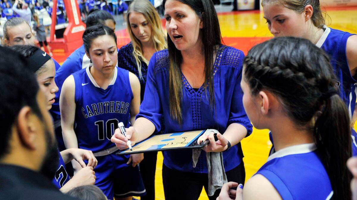 Caruthers head coach Anna Almeida, center, will guide her Blue Raiders into the Central Division Open Division.