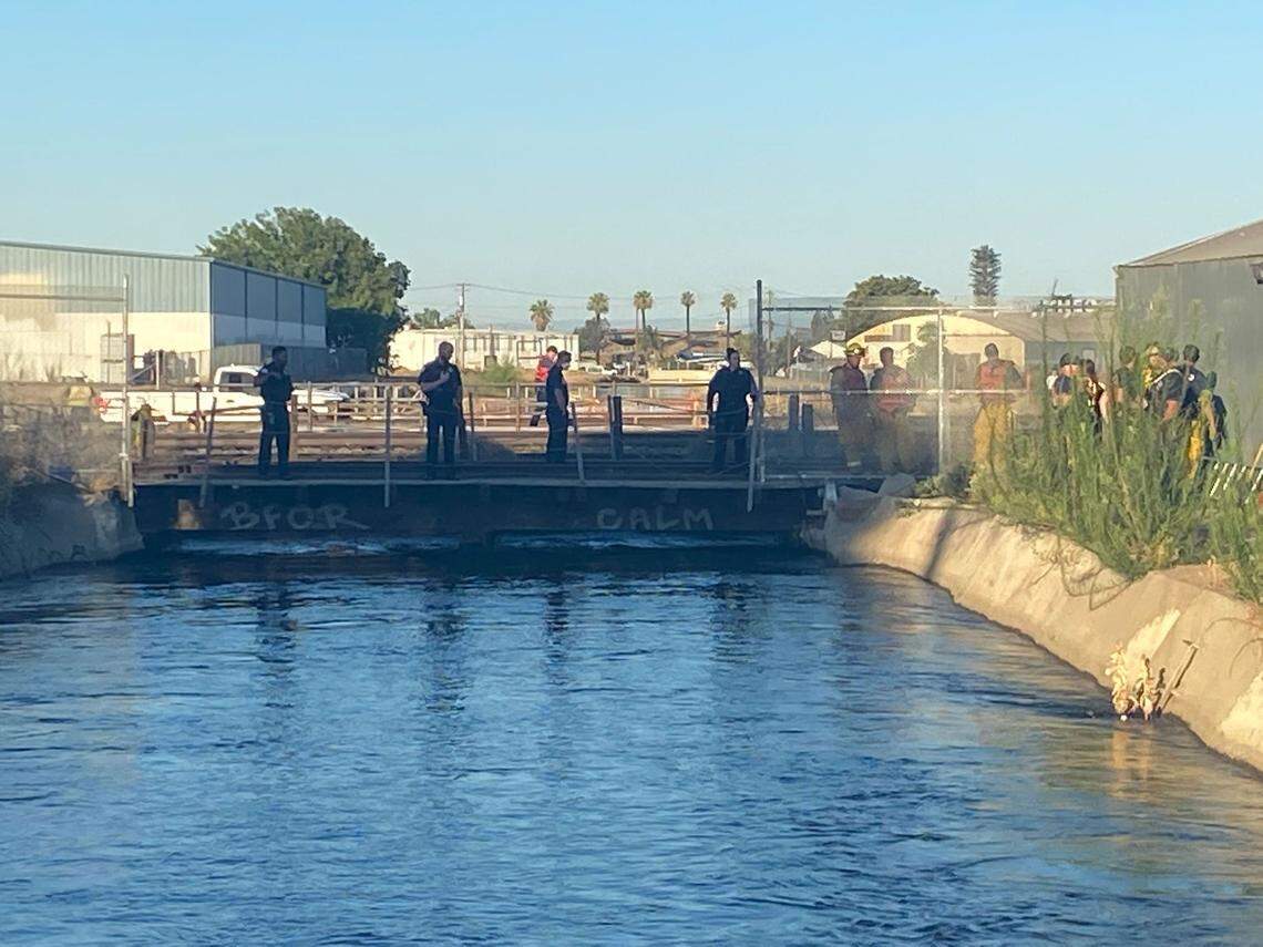 Emergency personnel responded to a body submerged in a canal in central Fresno on Wednesday, July 20, 2022.
