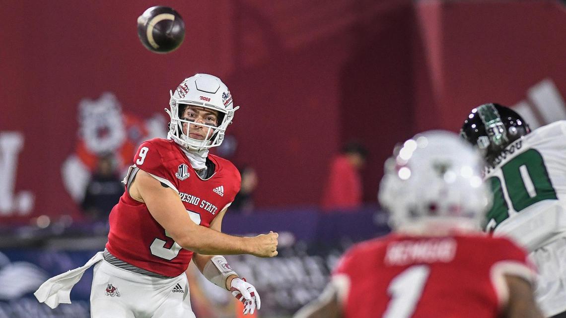 Former Fresno State quarterback Jake Haener throws to receiver Nikko Remigio in the first half of their game against Hawaii at Valley Children’s Stadium on Saturday, Nov. 5, 2022.