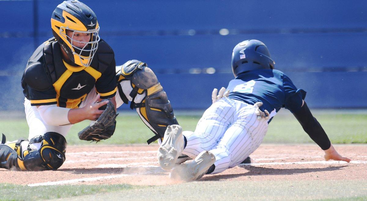 Bullard’s Beckett Zavorek, right, slides home safe as the Knights defeated the Edison Tigers 2-0 in a County/Metro Athletic Conference baseball game Saturday, March 26, 2022 in Fresno.