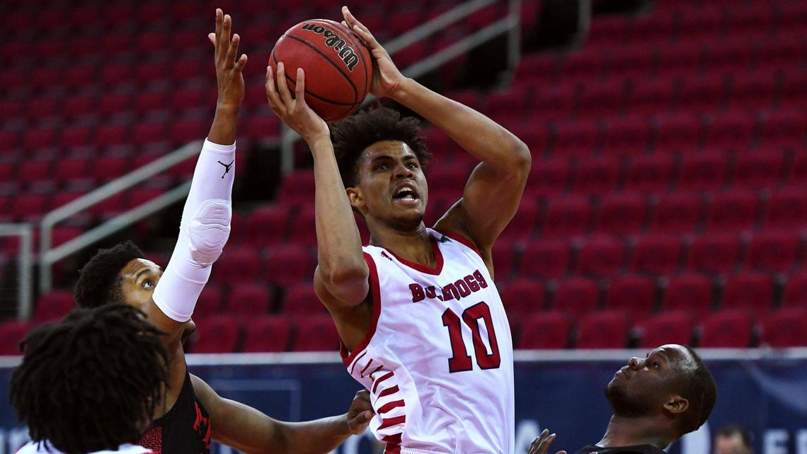 Fresno State forward Orlando Robinson, center, fights through San Diego State’s Joshua Tomaic, left, and Adam Seiko, right, Thursday night, Feb. 18, 2021 in Fresno. Robinson had a double-double with 17 points and 13 rebounds in the Bulldogs’ 67-53 loss.