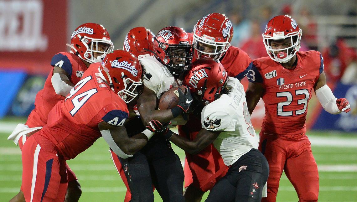 Fresno State defenders stack up UNLV running back Charles Williams during their game at Fresno State’s Bulldog Stadium on Friday, Oct. 18, 2019.