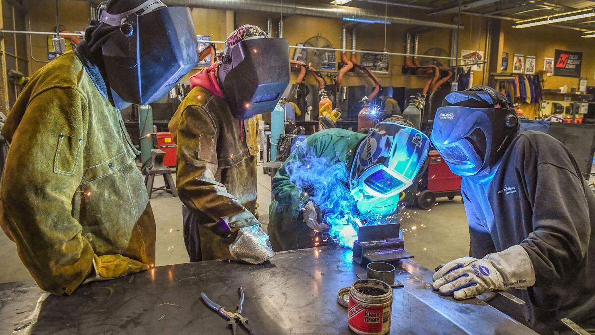 Welding instructor Greg Barragan, second from right, demonstrates for students during lab time in the Gladiator Welding Program at Washington Union High School on Monday, Dec. 6, 2021.