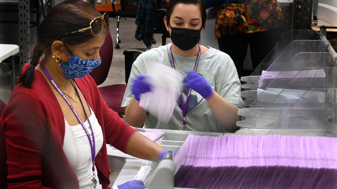 Fresno County election workers process ballots in November 2020. A week ahead of the June 2022 primary election, the county had received about 40,000 ballots, and election officials are urging in-person voters to do so early as well.