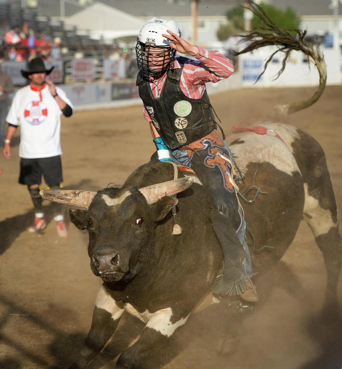 Pro bull rider Santiago Castellanos rides bull Judgement Day during the PBR event on the first night of the Clovis Rodeo at the Clovis Rodeo Grounds on Wednesday, April 21, 2021.