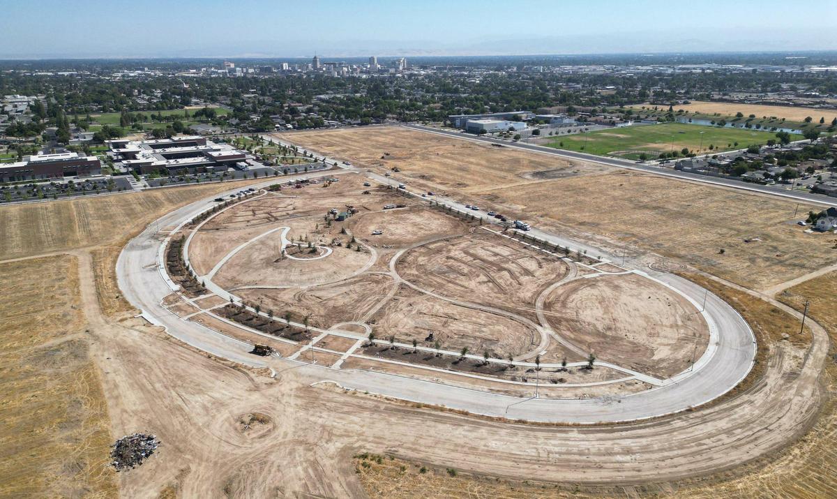 West Creek Village, a 10-acre park under development along South Martin Luther King Jr. Blvd just south of Church Ave. in west Fresno is seen with downtown Fresno skyline in the far distance on Friday, June 27, 2025. The park is next to the Fresno City College West Fresno Center, top left, and across the street from Gaston Middle School seen in the background to the right.