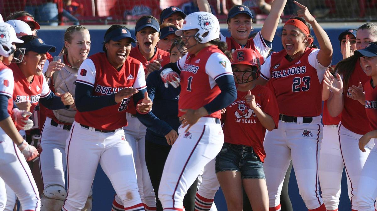Fresno State’s Keahilele Mattson, center, is welcomed at home plate after her home run in the first inning against the Nevada Wolfpack Friday, April 21, 2023 in Fresno.