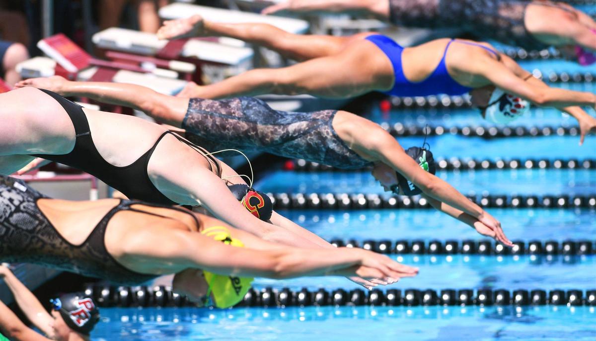Swimmers compete in the Girls 400 Yard Freestyle Relay at the Clovis West Invitational Saturday, April 15, 2023 in Fresno. Clovis Unified’s Olympic Swim Complex at Clovis West opened this week after being closed almost a year for renovation and construction.