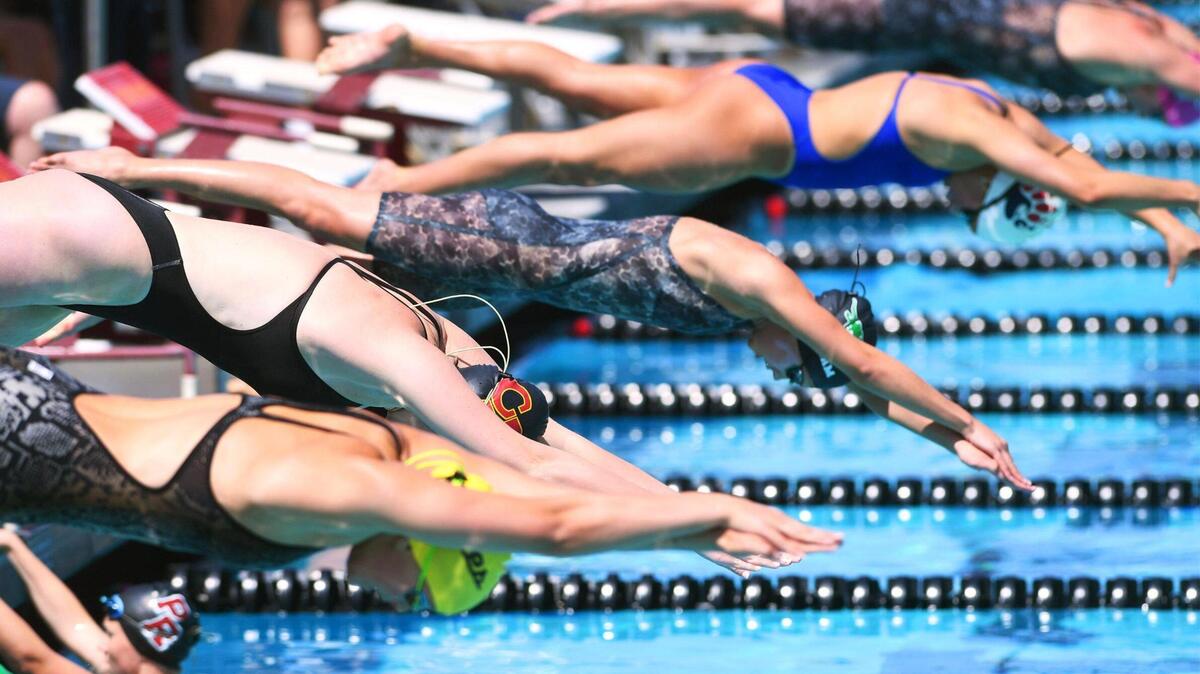 Swimmers compete in the Girls 400 Yard Freestyle Relay at the Clovis West Invitational Saturday, April 15, 2023 in Fresno. Clovis Unified’s Olympic Swim Complex at Clovis West opened this week after being closed almost a year for renovation and construction.