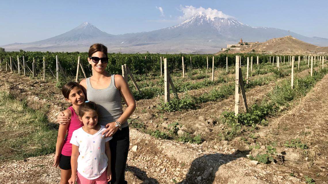 Jill Simonian with her daughters in Armenia. Mount Ararat is in the distance.
