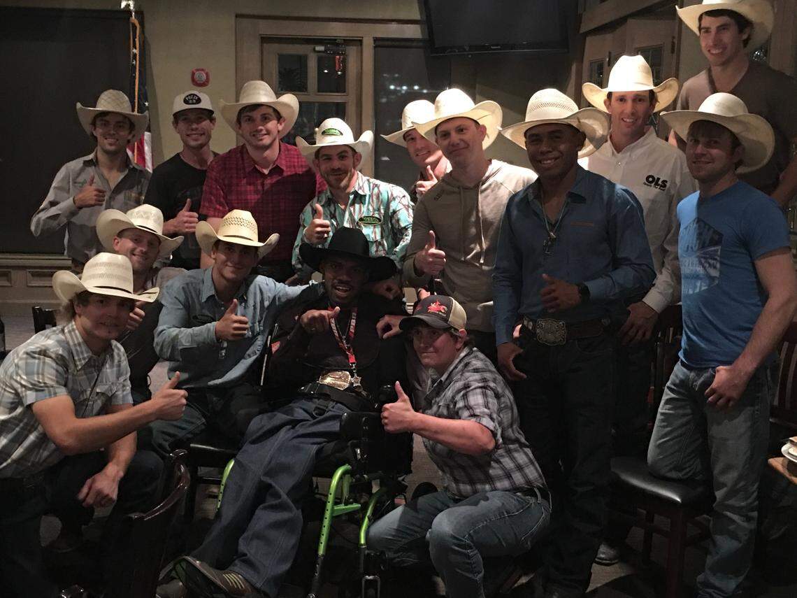 Mary Apper with PBR athletes and Tony Stephney, center in the black hat, after Apper gave him her Navy retirement flag in 2019 after he lost his.