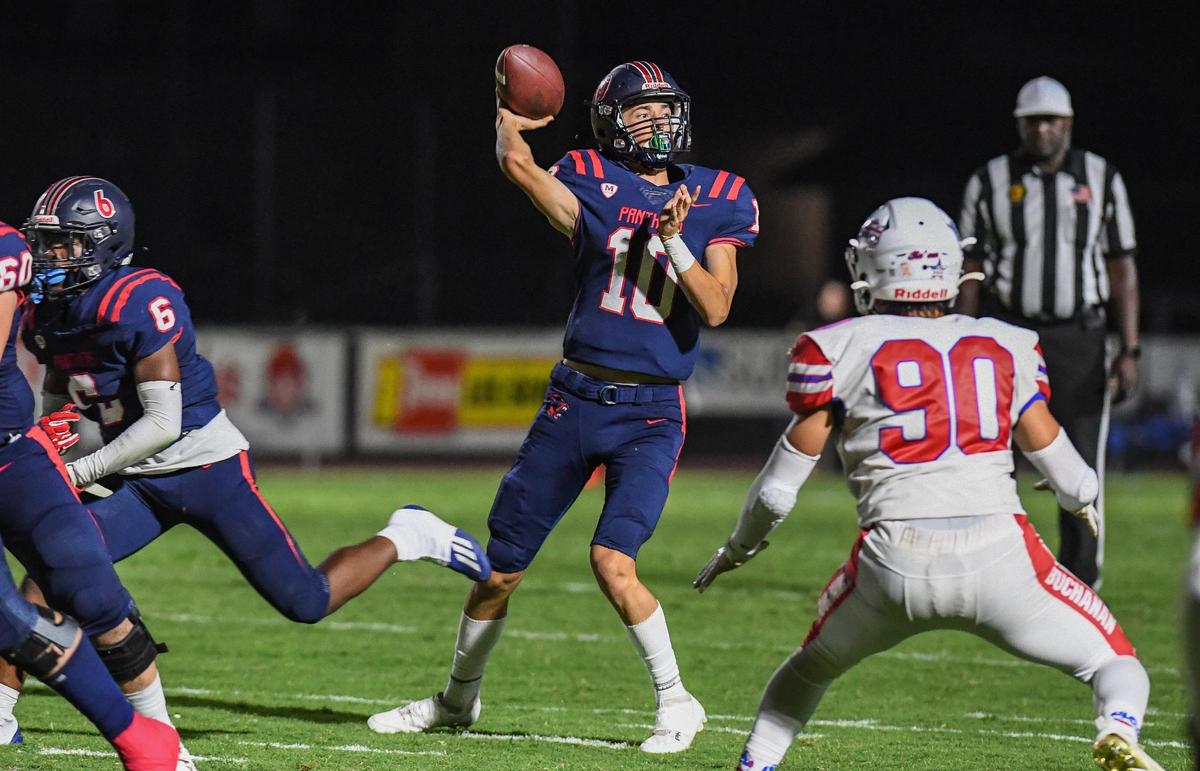 Memorial quarterback Carson Dean throws against the grain while getting pressure from Buchanan’s Aaron Nevarez during their game at San Joaquin Memorial on Friday, Sept. 16, 2022.