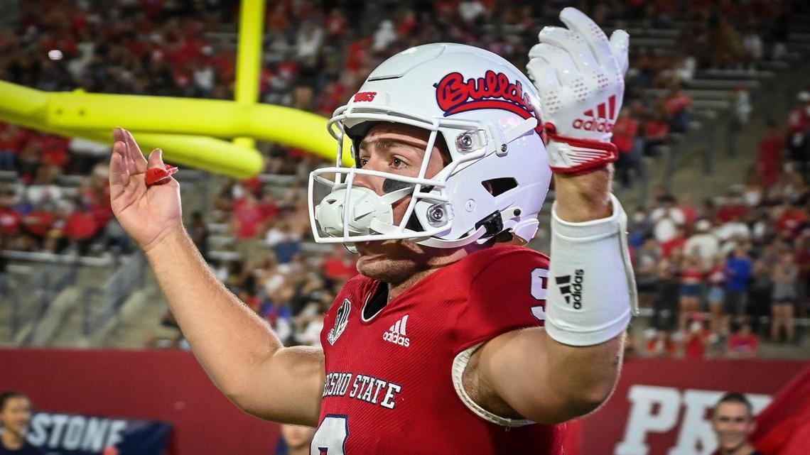 Fresno State quarterback Jake Haener cheers on the fans while running onto the field before the start of their game against Oregon State at Valley Children’s Stadium in Fresno on Saturday, Sept. 10, 2022.