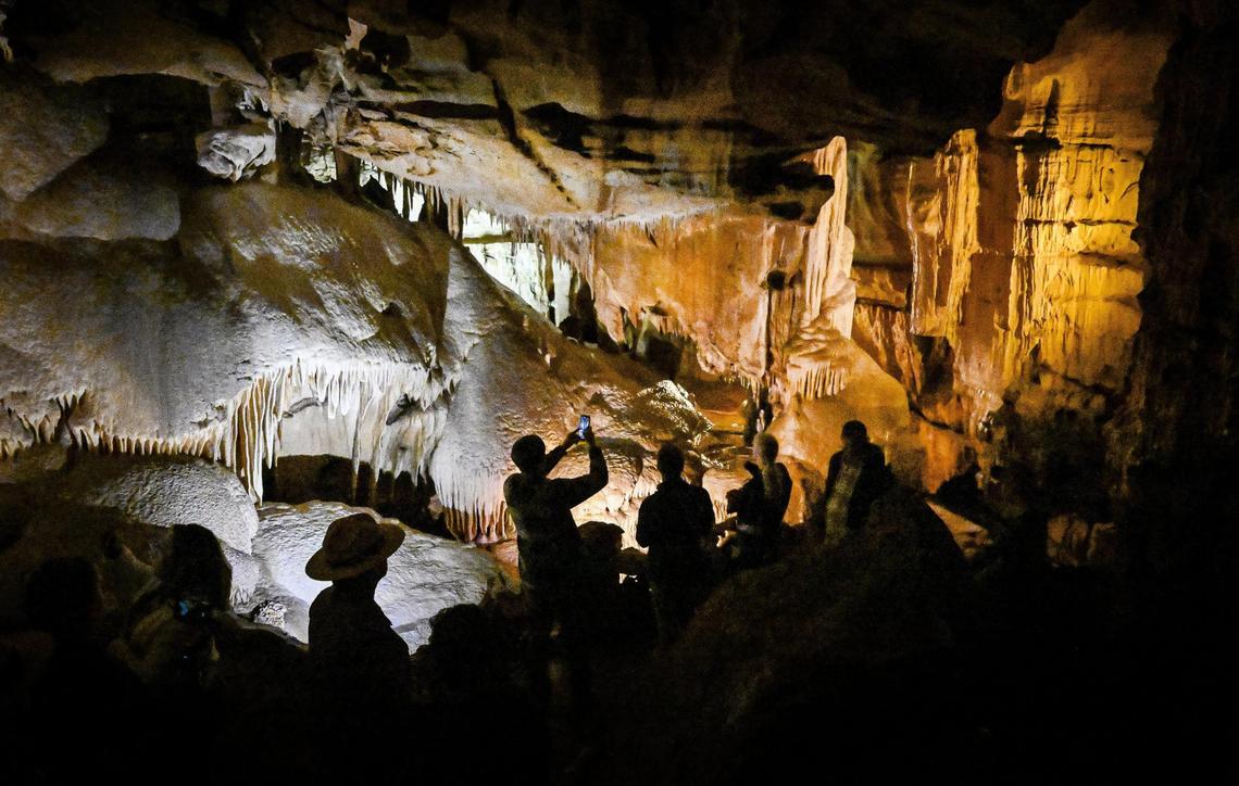 Visitors walk through the Dome Room in Crystal Cave within Sequoia National Park before reopening officially to the public following years of closures due to COVID, fires and floods.