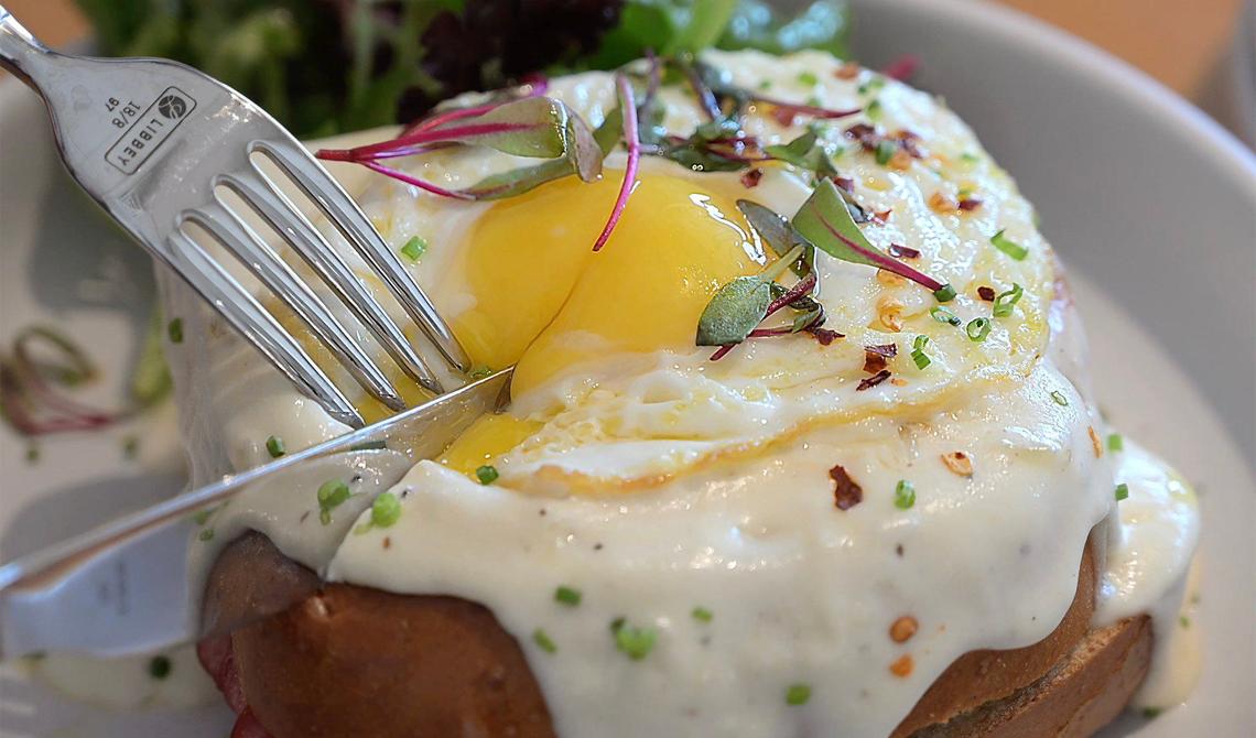 A knife slices into She’s Crafty, Yolked Kitchen’s version of the Croque Madame, Thursday, July 11, 2024 in Clovis.