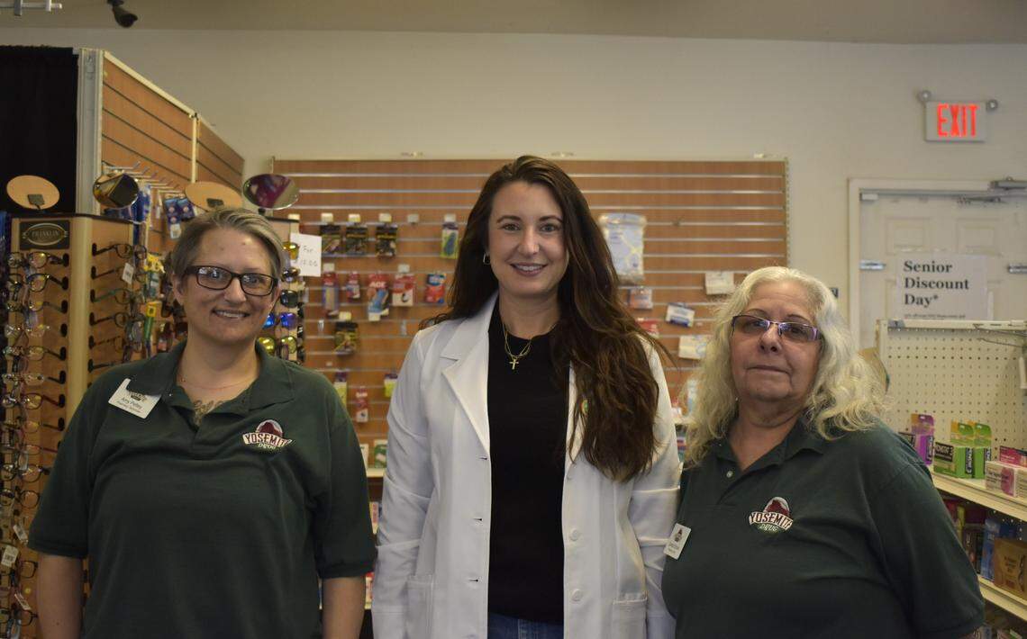 Yosemite Drug pharmacist Katie Bass, center, and staff members Amy Pettey, left, and Connie Schock, right, pose for a photo inside the pharmacy in Coarsegold on Friday, Feb. 21, 2025. Bass, the pharmacy’s owner, opened the family-owned store in 2019.