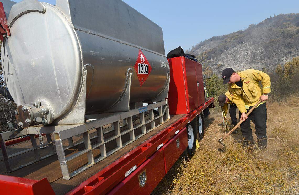 Cal Fire crews clear brush from the fuel mixing unit in preparation, Monday Sept. 21, 2020, for use of a helitorch attack on the Creek Fire. It is an aerial ignition system carried out by helicopters in areas that would otherwise be inaccessible to ground crews.