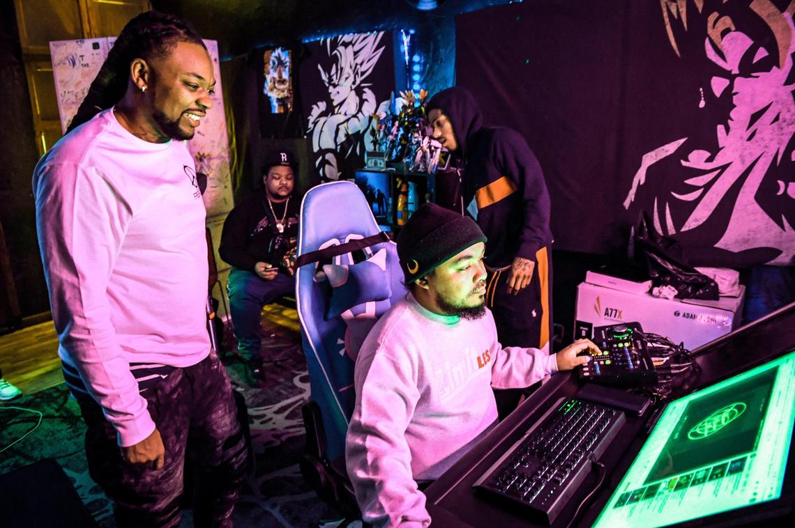 Local rapper Syrup, left, whose real name is Roger Brown, an Advance Peace “change agent,” watches as De’Andre Monia engineers a track performed by an Advance Peace fellow during a recording session in Fresno on Wednesday, March 17, 2021.