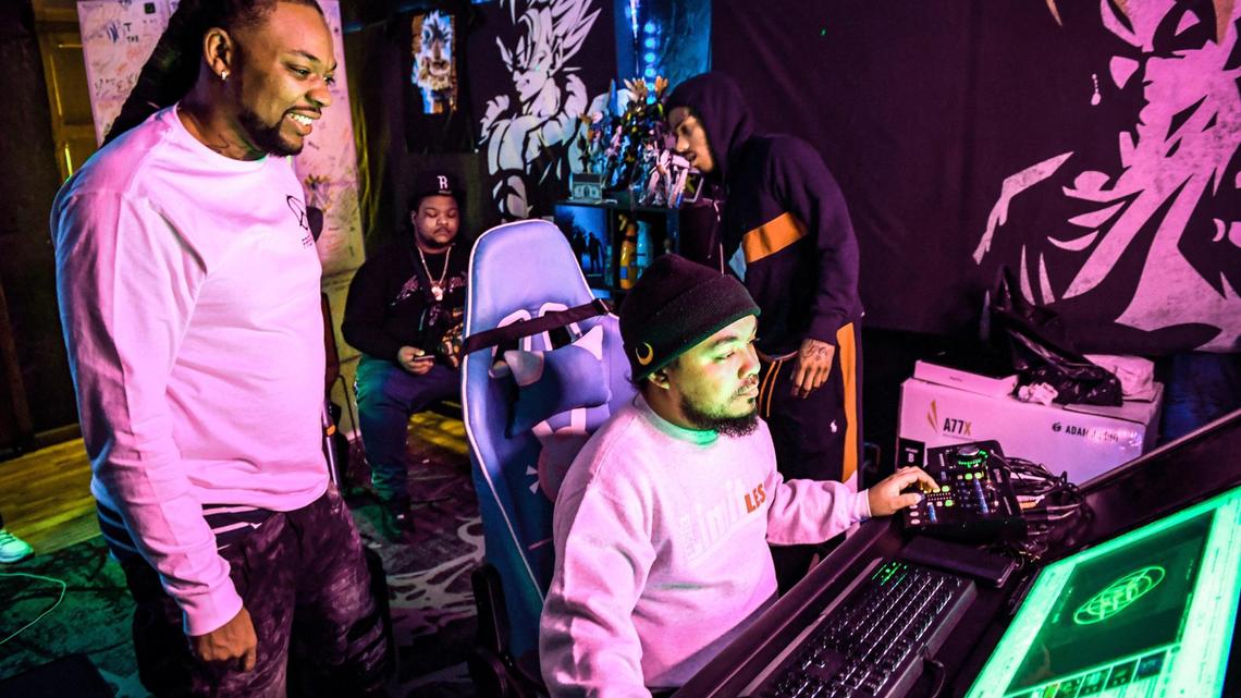 Local rapper Syrup, left, whose real name is Roger Brown, an Advance Peace “change agent,” watches as De’Andre Monia engineers a track performed by an Advance Peace fellow during a recording session in Fresno on Wednesday, March 17, 2021.