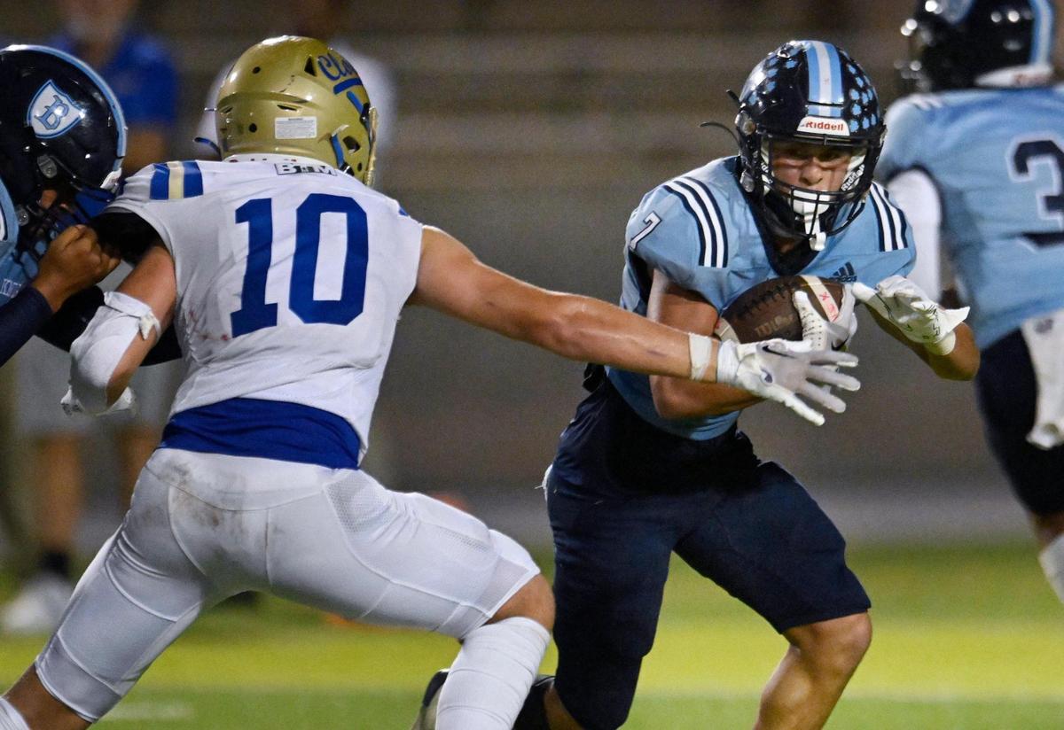 Clovis High’s John Villanueva, left, reaches out for Bullard’s Dominick Gonzalez, right, Friday, Sept. 15, 2023 in Fresno.