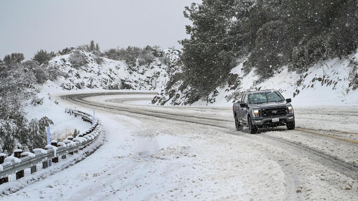 A vehicle drives up the four lane section of Highway 168 west of Pine Ridge during a snowstorm on Monday, Dec. 27, 2021.