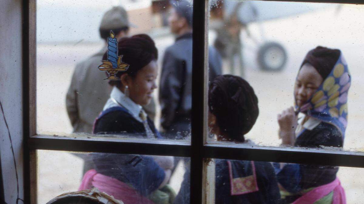 In this image, “Window to the Past,” Galen Beery photographed Hmong women conversing in front of airstrip at Sam Thong, Laos in 1966.