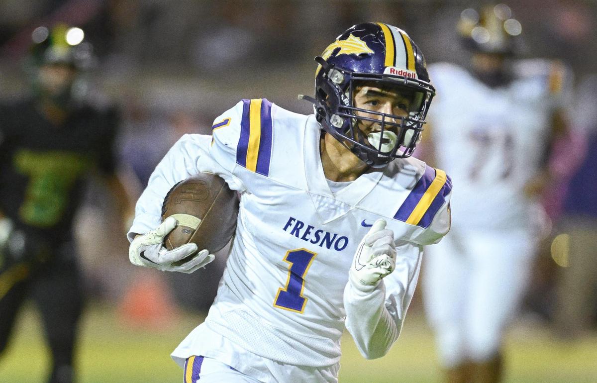 Fresno High wide receiver Isiah Gonzalez takes the ball up the sideline on a long play during the annual Little Big Game against Roosevelt at Sunnyside High School Stadium on Friday, Oct. 27, 2023.
