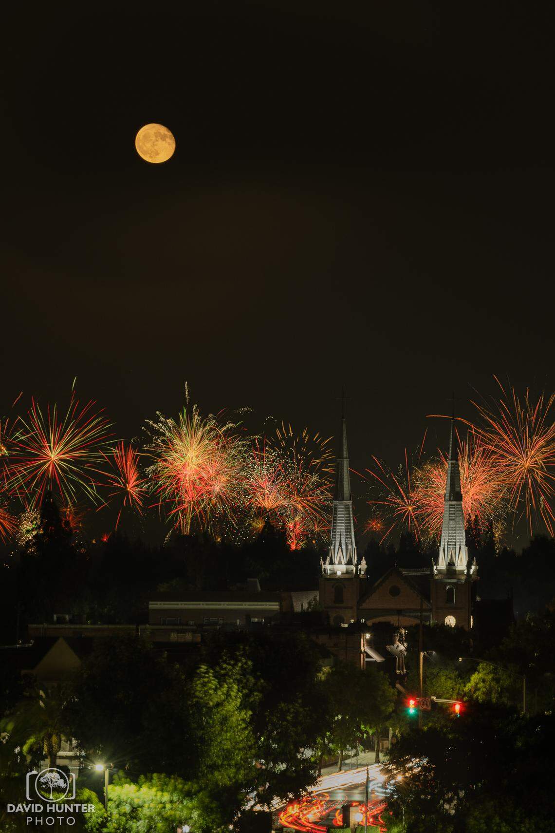 Fireworks displays light up the evening skies above St. John’s Cathedral in downtown Fresno on July 4th, 2023, as captured from the Community Regional Medical Center parking garage by local photographer David Hunter.