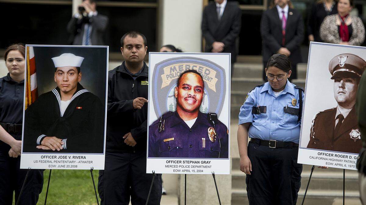Photos of fallen law enforcement officers are displayed during the annual Merced County Peace Officers Memorial in Merced, Calif., on Wednesday, May 15, 2019. The ceremony is held to honor law enforcement officers who have died in the line of duty.