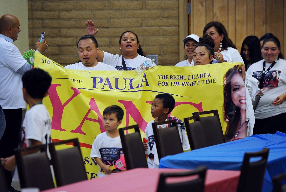 Supporters of Paula Yang march into a District 5 community forum held at the Sal Mosqueda Community Center Tuesday, Oct. 2, 2018 in Fresno.