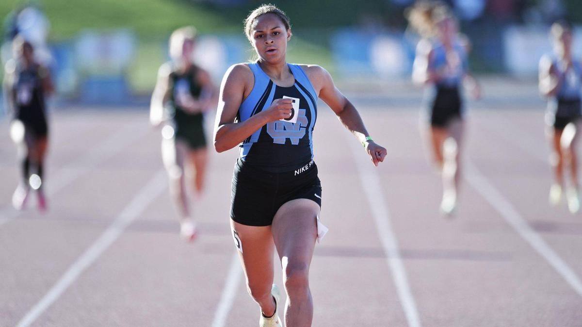 Clovis North’s Takiya Cenci, center, easily places first far ahead of the field in the 400 at the Central Section Masters held at Buchanan High School Saturday, May 21, 2022 in Clovis.