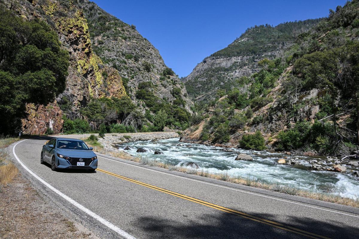 A car veers around Highway 180 that follows the south fork of the Kings River a short distance from Kings Canyon National Park’s Cedar Grove on Tuesday, June 11, 2024.