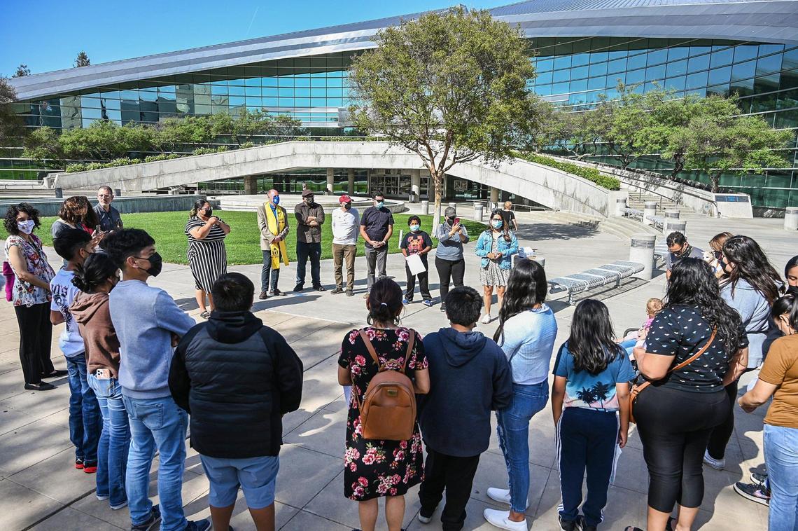 Trails End Mobile Home Park residents and advocates gather outside Fresno City Hall before going in to ask city leaders to help them block the sale of the park to Harmony Communities, on Tuesday, April 5, 2022.