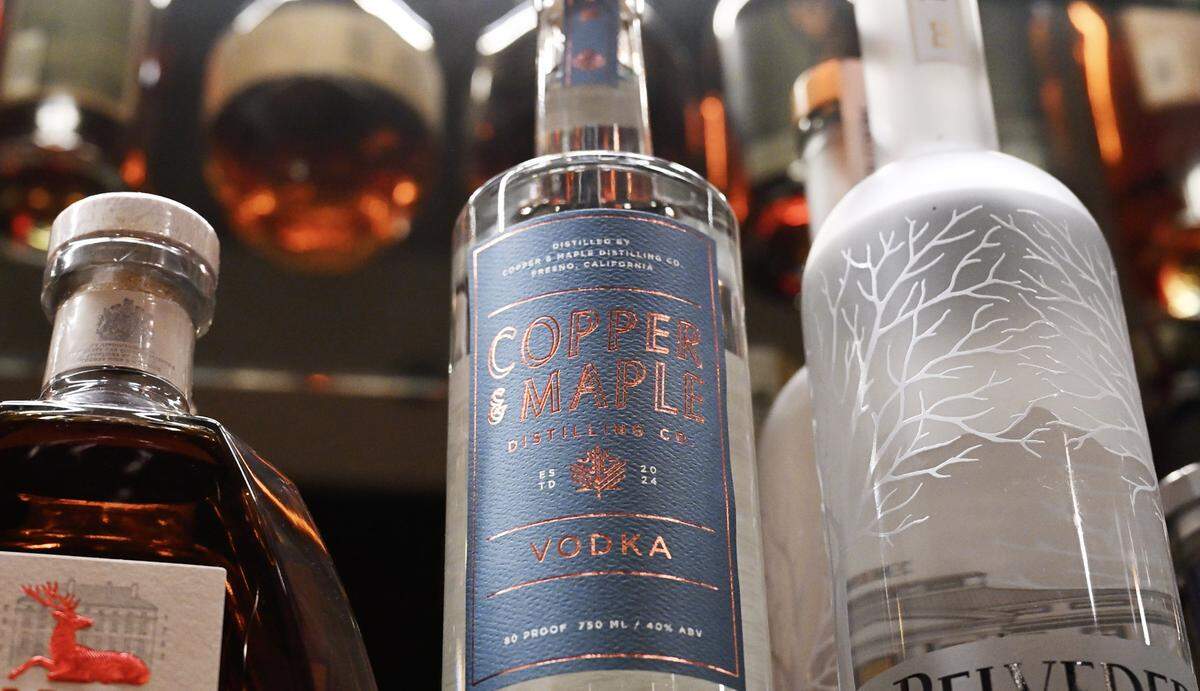 Vodka made by Maple & Copper Distilling Company, center, seen with other spirits at The Golden Hour Cocktail Lounge Wednesday, Feb. 4, 2026 in Fresno. Maple & Copper Distilling Company has set up shop next to The Golden Hour to help provide spirits through its distilling facility.