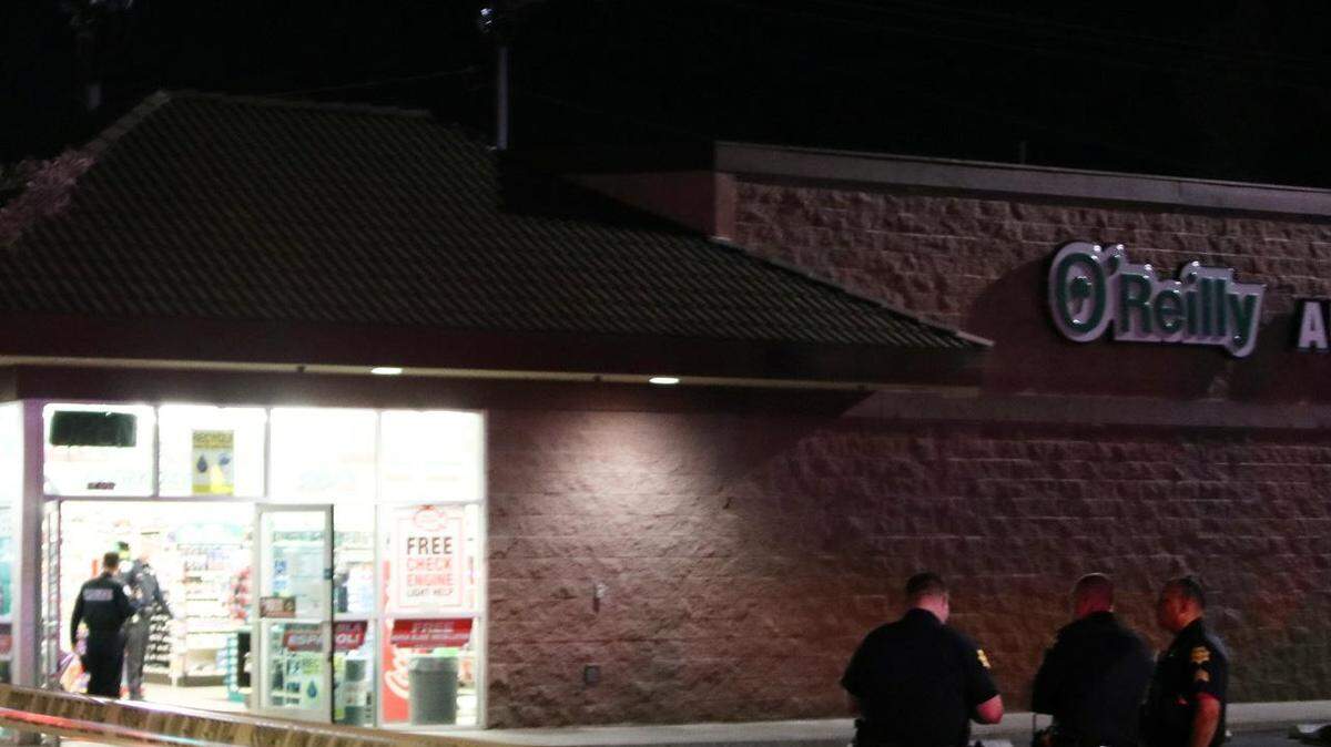 Police work the scene after an employee at O'Reilly Auto Parts at Blackstone and Sierra avenues was shot during an alleged robbery on Thursday, April 19, 2018, in Fresno, California.