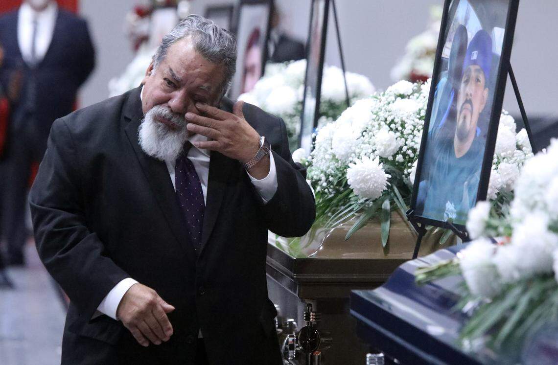 Reade & Sons Funeral Home worker Bob Arriaga gets emotional near the casket of Juvenal Jacobo Talavera, one of seven farmworkers who died in a Feb. 23 crash on a rural Madera County Road during a Mass and funeral service at the Kerman High School multi-purpose room on March 9, 2024.
