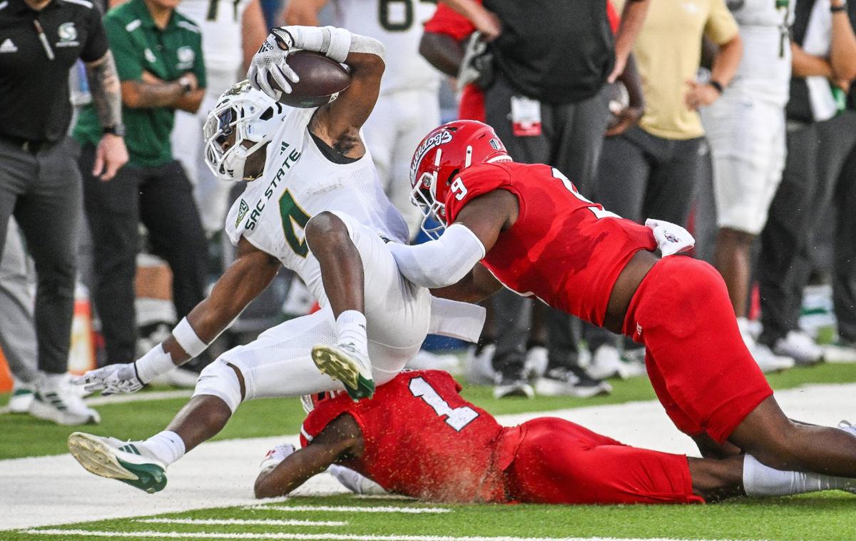 Fresno State linebacker Malachi Langley, right, and defensive back Cam Lockridge force Sacramento State’s Elijah Tau-Tolliver out of bounds on a play during their game at Valley Children’s Stadium on Saturday, Sept. 7, 2024.