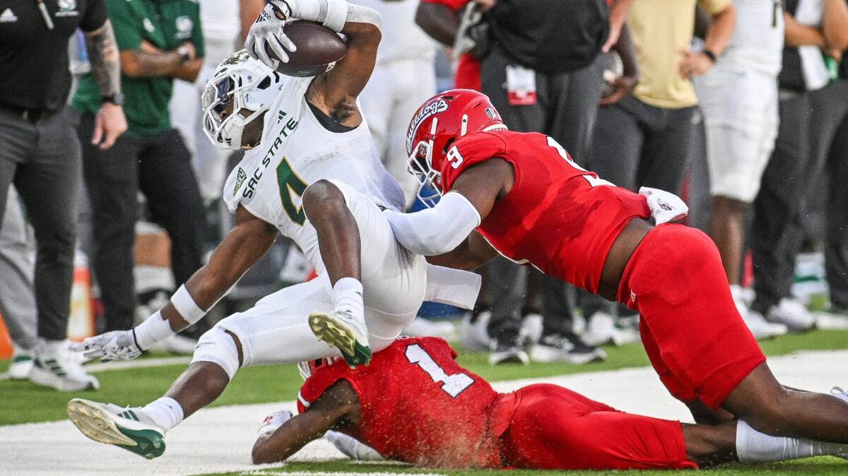 Fresno State linebacker Malachi Langley, right, and defensive back Cam Lockridge force Sacramento State’s Elijah Tau-Tolliver out of bounds on a play during their game at Valley Children’s Stadium on Sept. 7. Tau-Tolliver left in the first half of Saturday’s loss to the Idaho State Bengals with an injury.