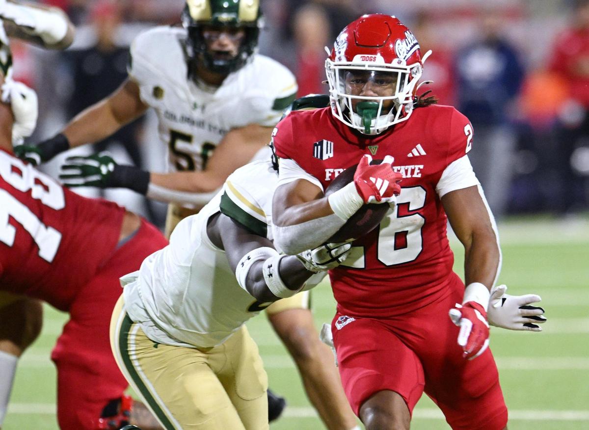 Fresno State’s Bryson Donelson, right, cuts through the Colorado State defense Saturday, Nov. 23, 2024 in Fresno.