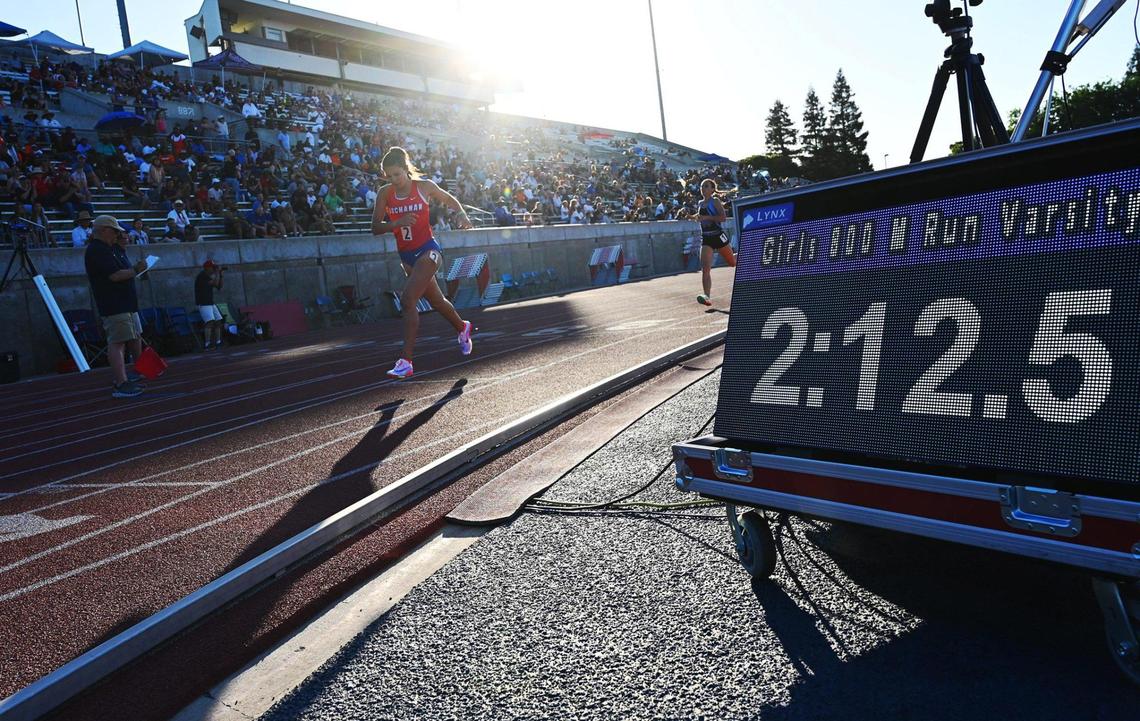 Buchanan’s Elle Lomeli, left, places first in the 800 at the Central Section Masters held at Buchanan High School Saturday, May 21, 2022 in Clovis.