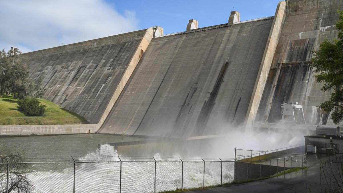 Water is released from the base of Friant Dam at a rate of more than 8,000 cubic feet per second on Tuesday, April 11, 2023 to make room in Millerton Lake for the expected spring and summer melt of the record snowpack in the Sierra Nevada. Officials are expecting the lake will fill to the top this spring, causing water to pour over the spillway causing more issues downstream.