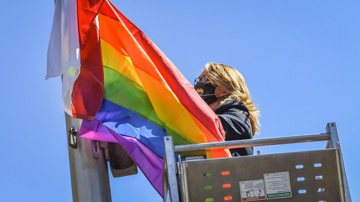 Fresno City College President Dr. Carole Goldsmith attaches the Pride flag to the school’s flag pole before raising it during a ceremony to recognize Pride Month on Friday, June 4, 2021.