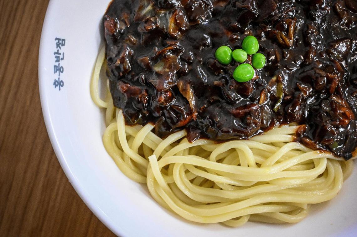 An order of Jajangmyeon, which is noodles with a savory black bean sauce, pork and vegetables, is prepared for a customer at Paik’s Noodle in north Fresno on Monday, Jan. 27. 2025.