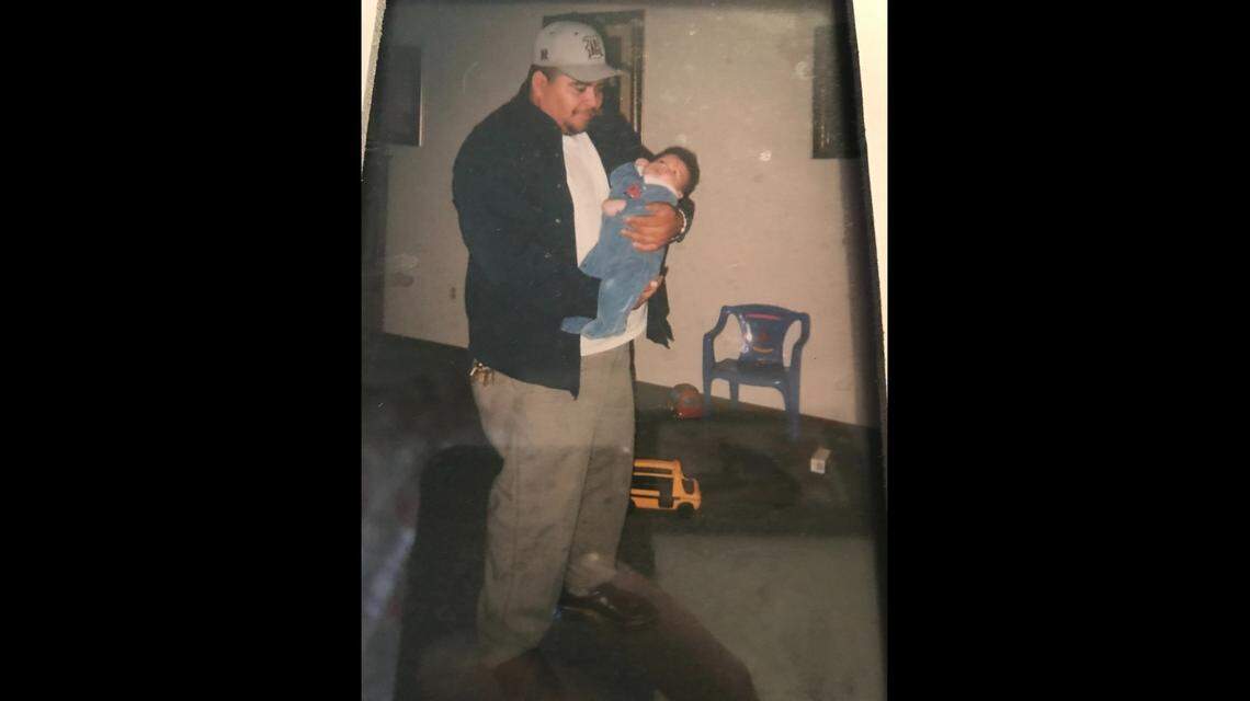 Farmworker Rafael Cerda Martinez holding his son, Rafael, after work circa 2005. Cerda and his wife are suing agricultural pesticide company Corteva, Inc. for the alleged effects of pesticides on his son’s development.